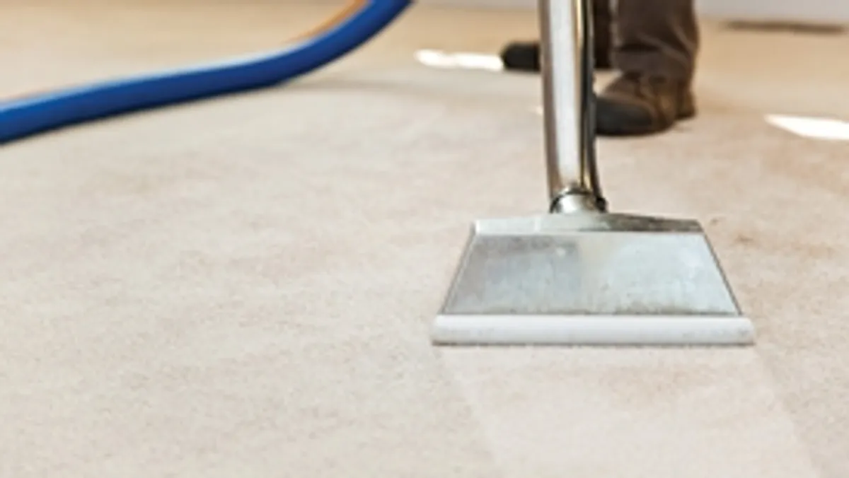Carpet cleaning wand head gliding over a light carpet during hot-water extraction, St Paul, MN.
